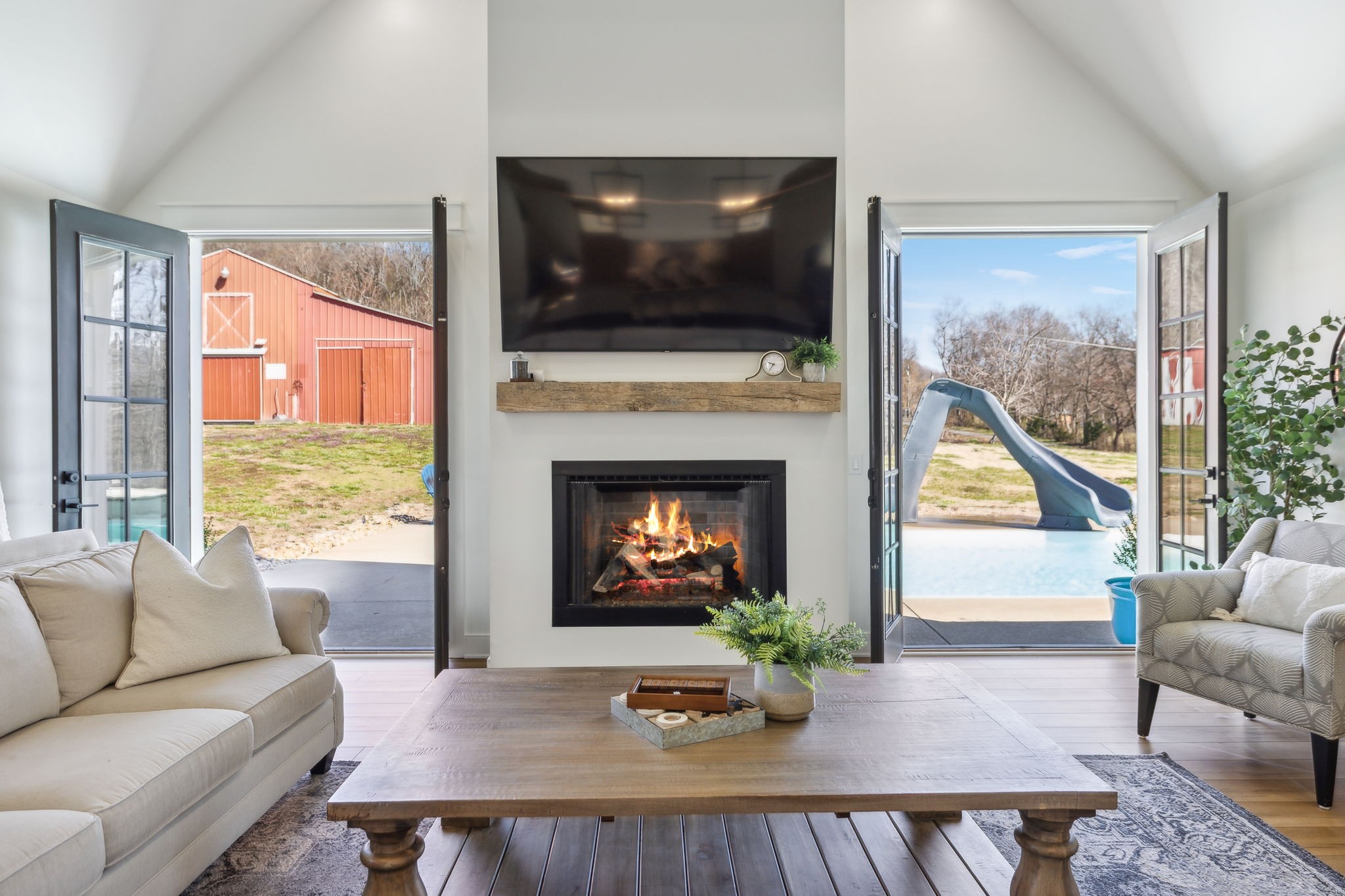 4676 Reed Road Thompson's Station, TN 37179 - Photo 34 of 67 a living room with furniture a fireplace and a flat screen tv