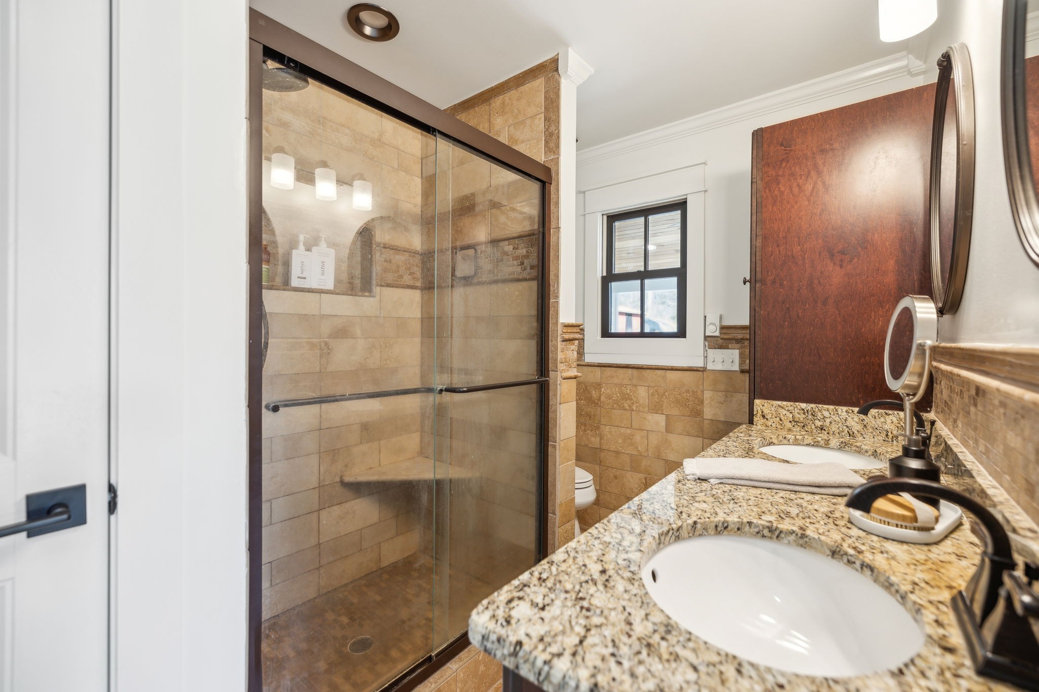 4676 Reed Road Thompson's Station, TN 37179 - Photo 45 of 67 a bathroom with a granite countertop sink a mirror and shower