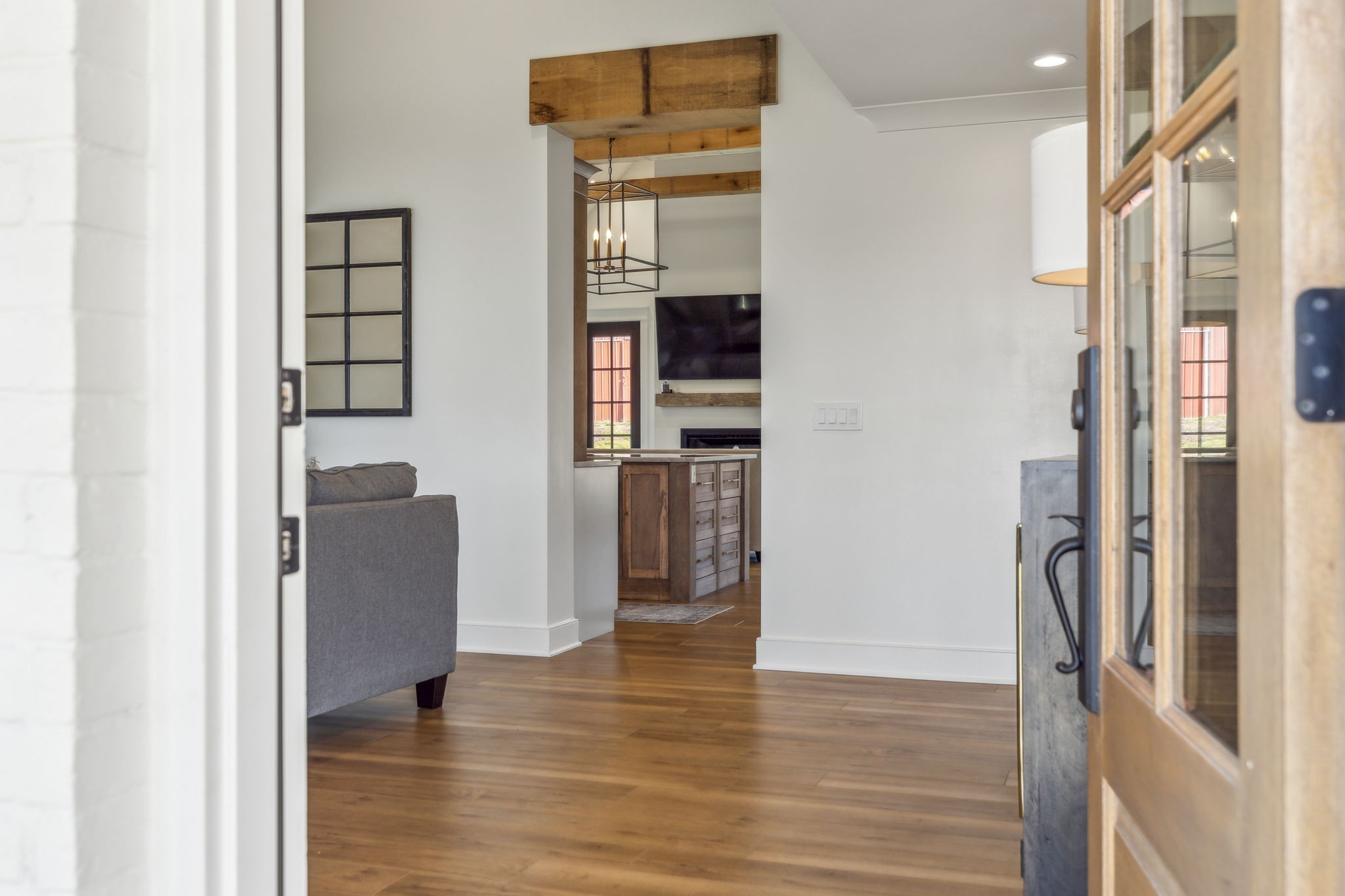 4676 Reed Road Thompson's Station, TN 37179 - Photo 5 of 67 a view of a hallway with wooden floor and a living room