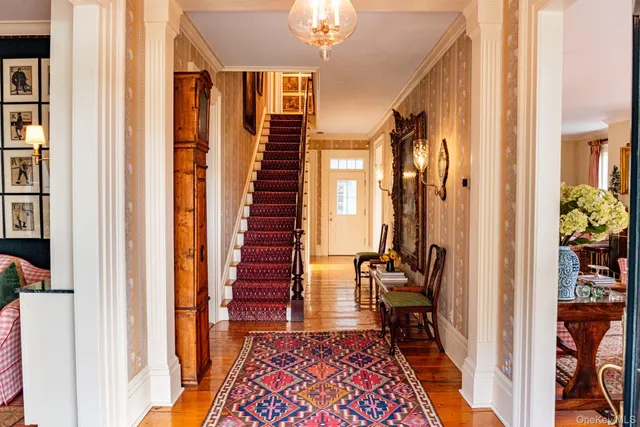 a dining room with furniture and a rug
