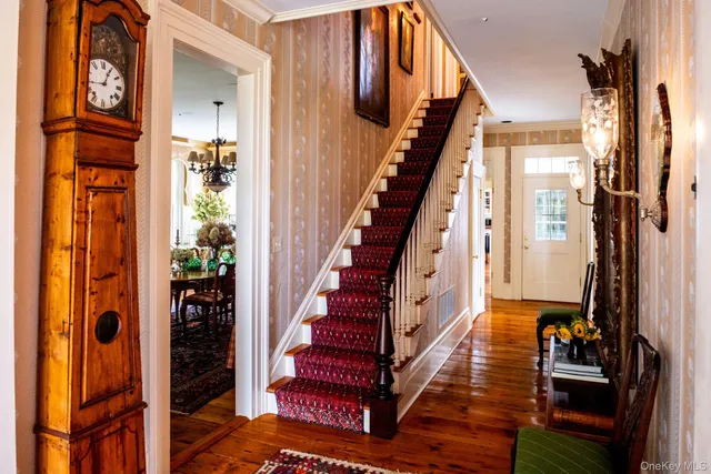 a view of an entryway with wooden floor and staircase