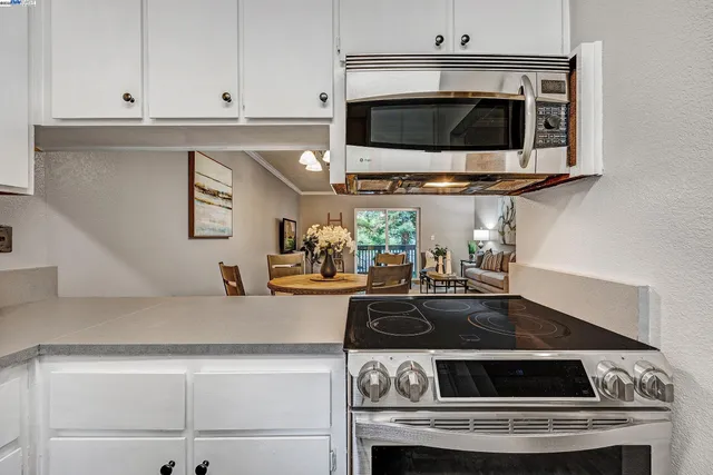 a kitchen with granite countertop a stove and a sink