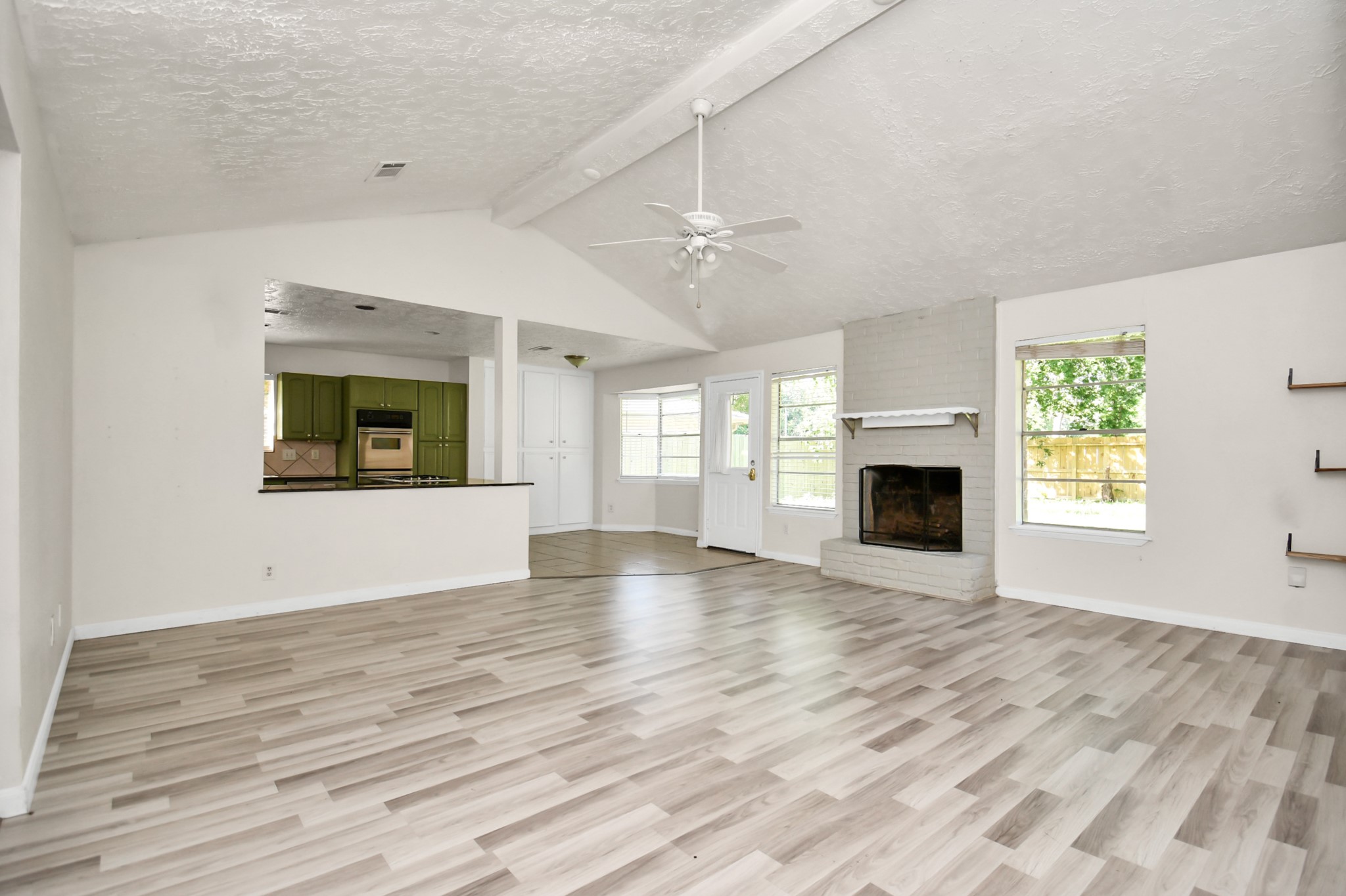 18023 Woodgum Drive Spring, TX 77388 - Photo 11 of 38 an empty room with windows fireplace and sink