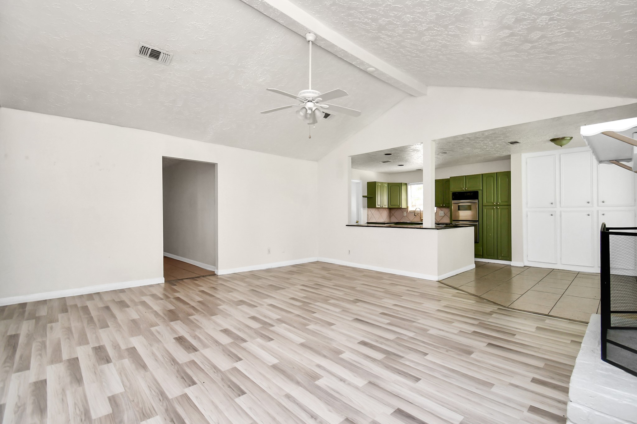 18023 Woodgum Drive Spring, TX 77388 - Photo 12 of 38 a view of empty room with wooden floor and a ceiling fan
