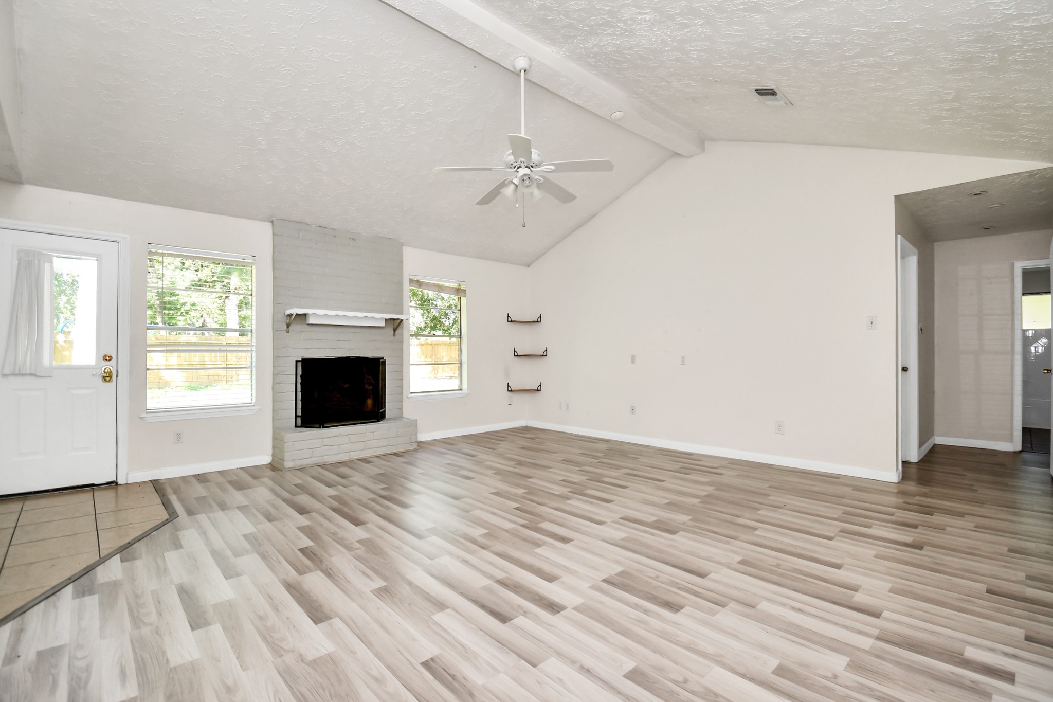 18023 Woodgum Drive Spring, TX 77388 - Photo 14 of 38 an empty room with windows and fireplace