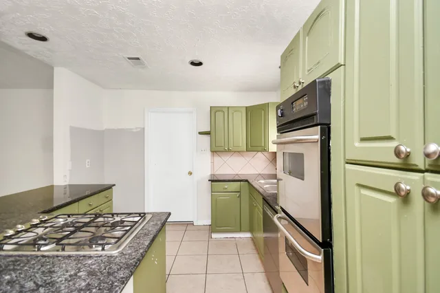 a kitchen with a refrigerator and a stove