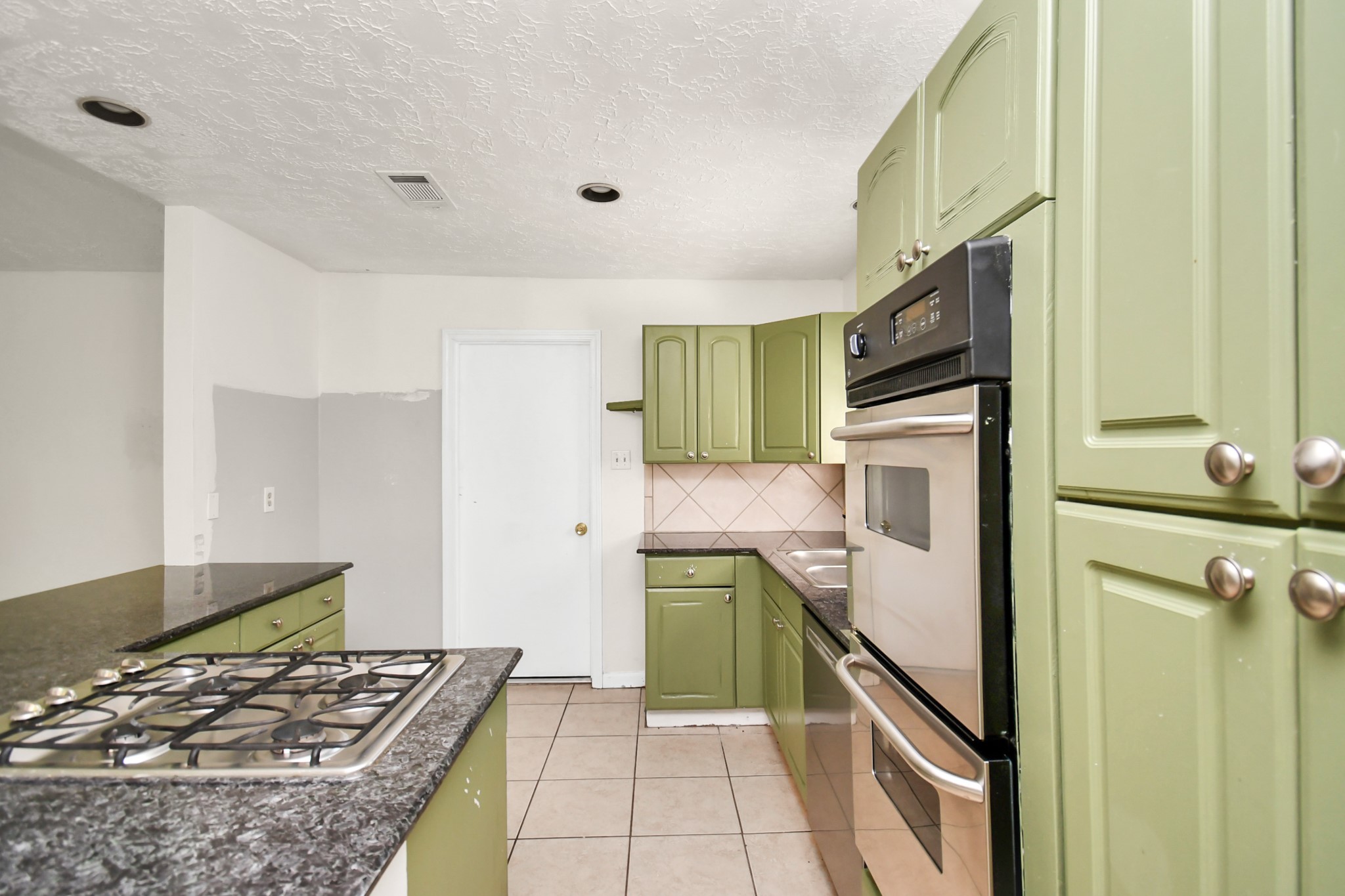 18023 Woodgum Drive Spring, TX 77388 - Photo 16 of 38 a kitchen with a refrigerator and a stove