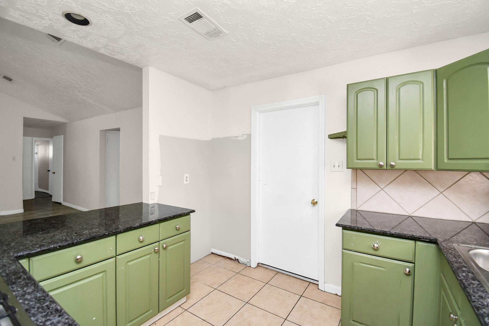 18023 Woodgum Drive Spring, TX 77388 - Photo 19 of 38 a kitchen with a sink and a refrigerator
