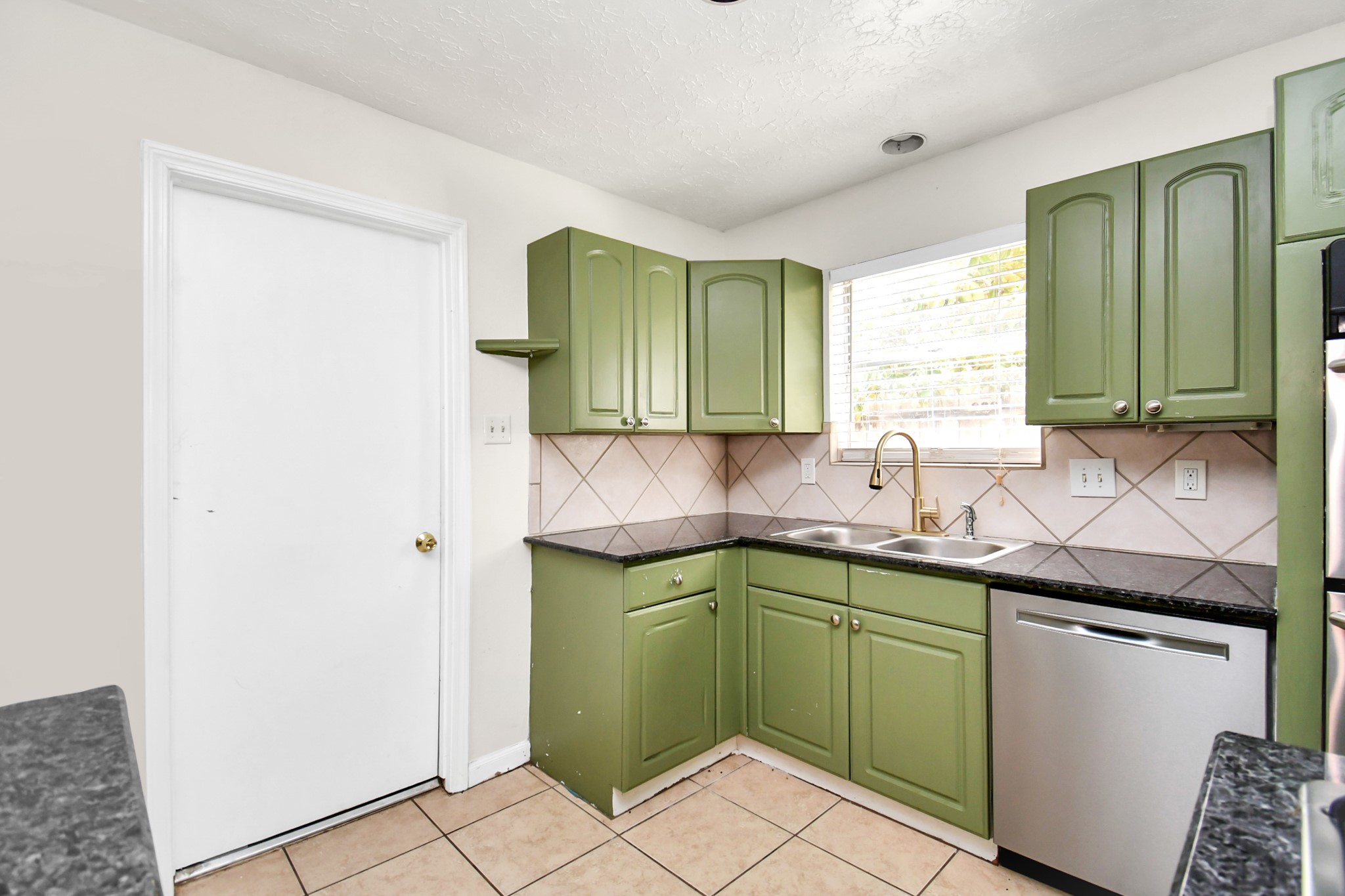 18023 Woodgum Drive Spring, TX 77388 - Photo 21 of 38 a kitchen with a sink and cabinets