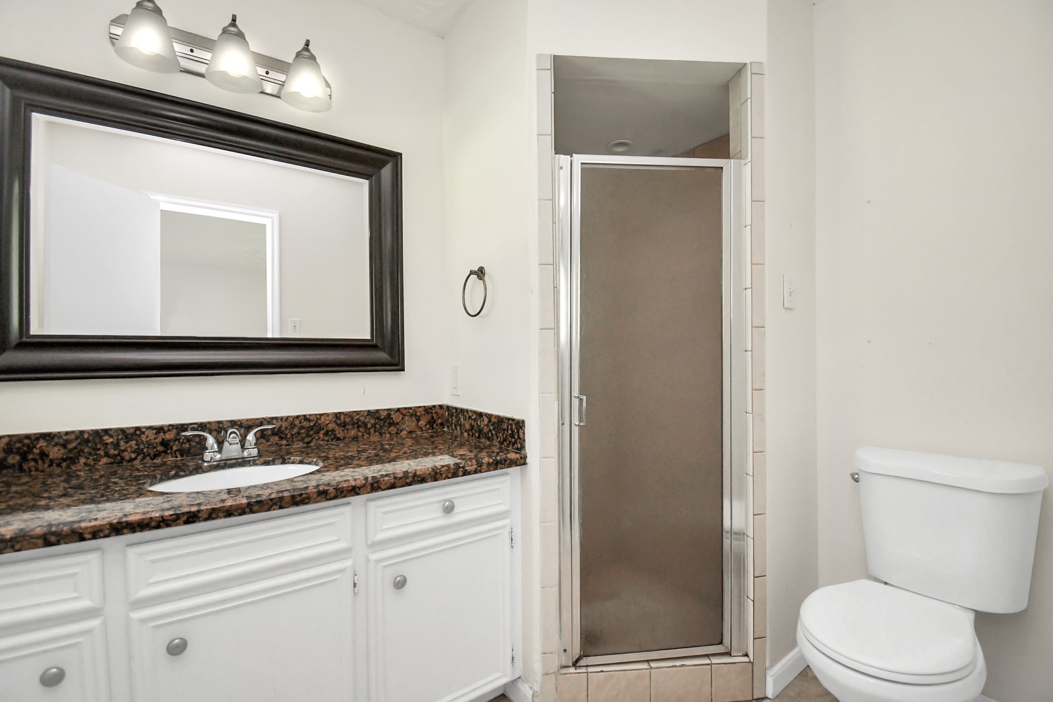 18023 Woodgum Drive Spring, TX 77388 - Photo 25 of 38 a bathroom with a sink a toilet and vanity
