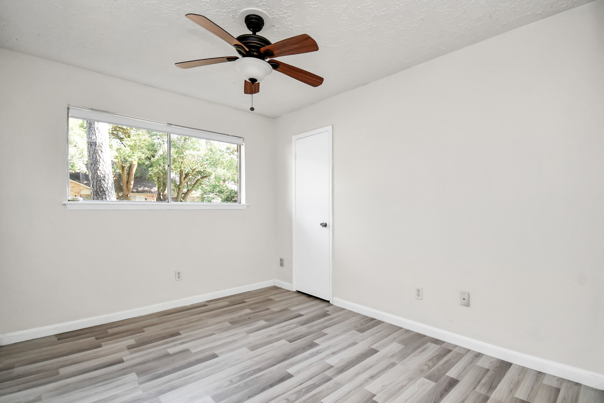 18023 Woodgum Drive Spring, TX 77388 - Photo 27 of 38 an empty room with wooden floor and windows