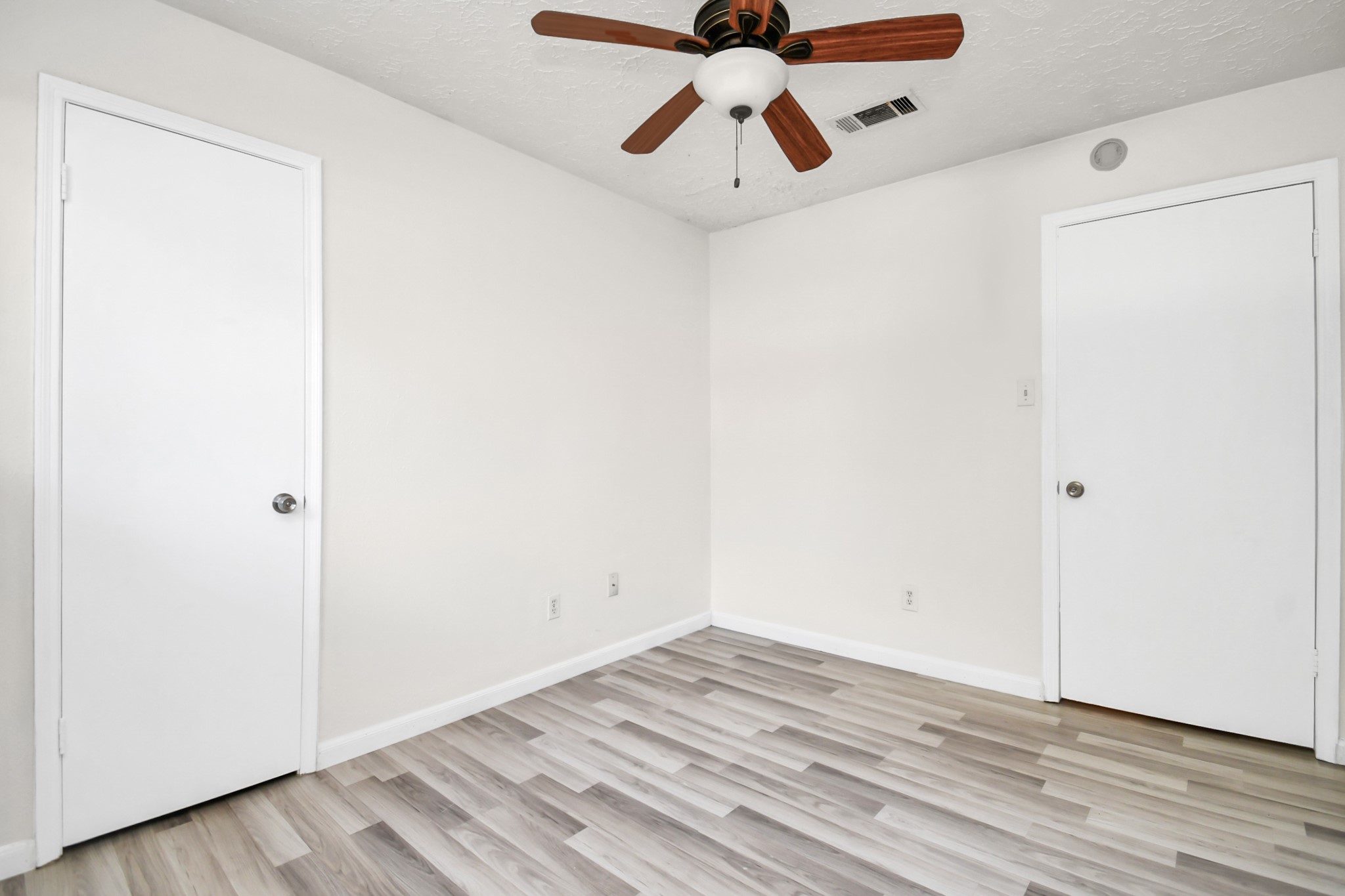 18023 Woodgum Drive Spring, TX 77388 - Photo 28 of 38 an empty room with wooden floor ceiling fan and carpet