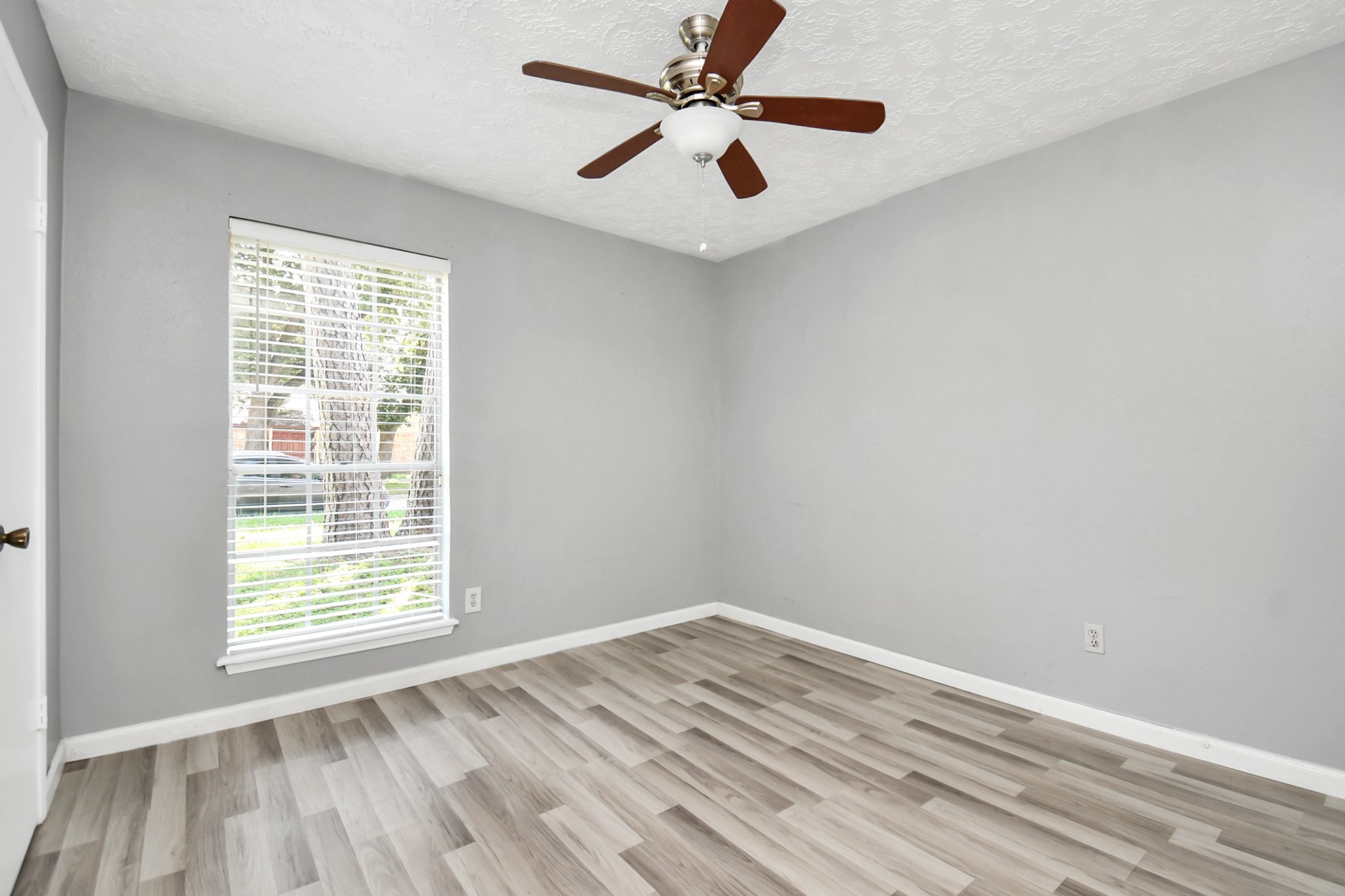 18023 Woodgum Drive Spring, TX 77388 - Photo 30 of 38 a view of empty room with wooden floor and fan