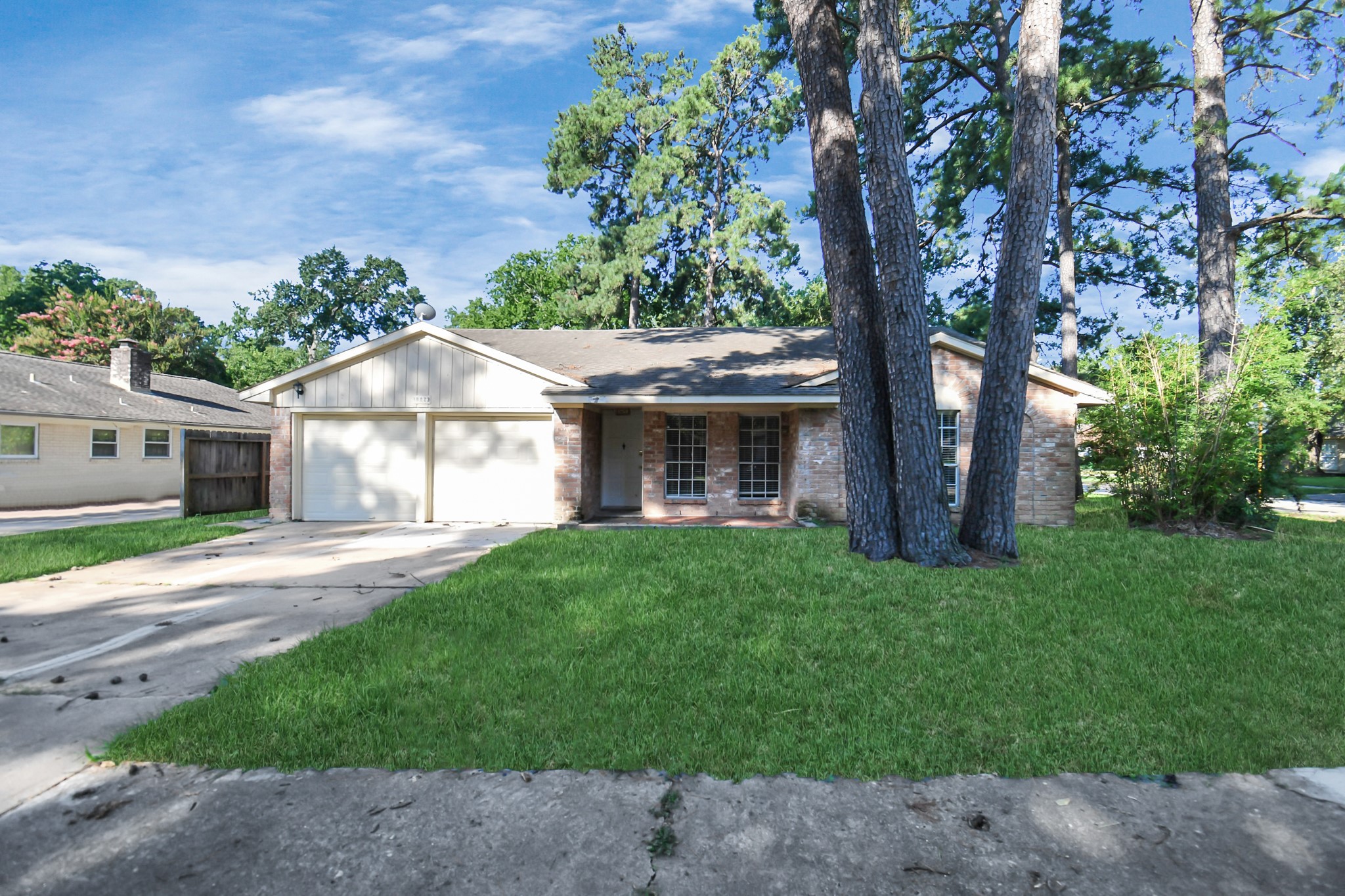 18023 Woodgum Drive Spring, TX 77388 - Photo 3 of 38 a front view of a house with a garden and yard