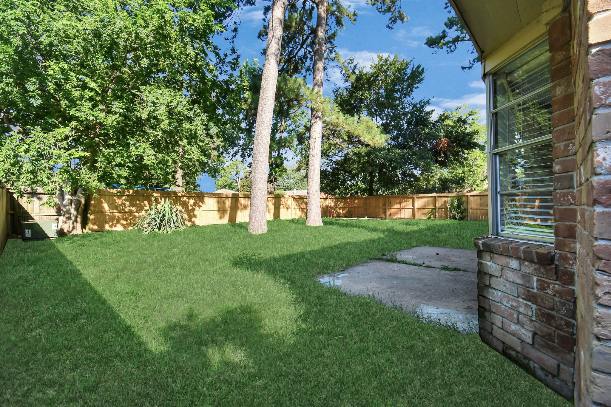 18023 Woodgum Drive Spring, TX 77388 - Photo 32 of 38 a view of a yard with a tree