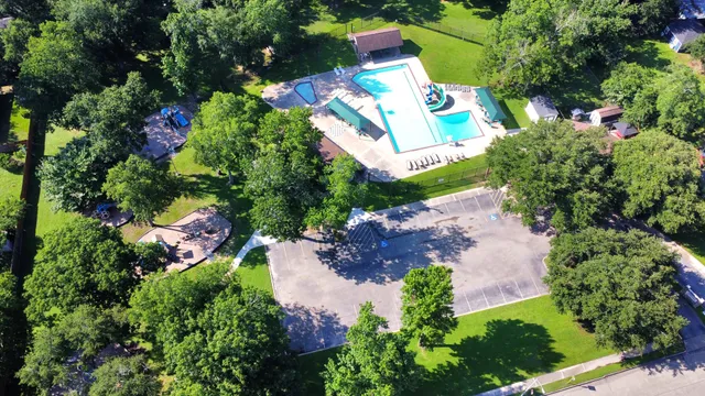 an aerial view of a house with a yard and fountain
