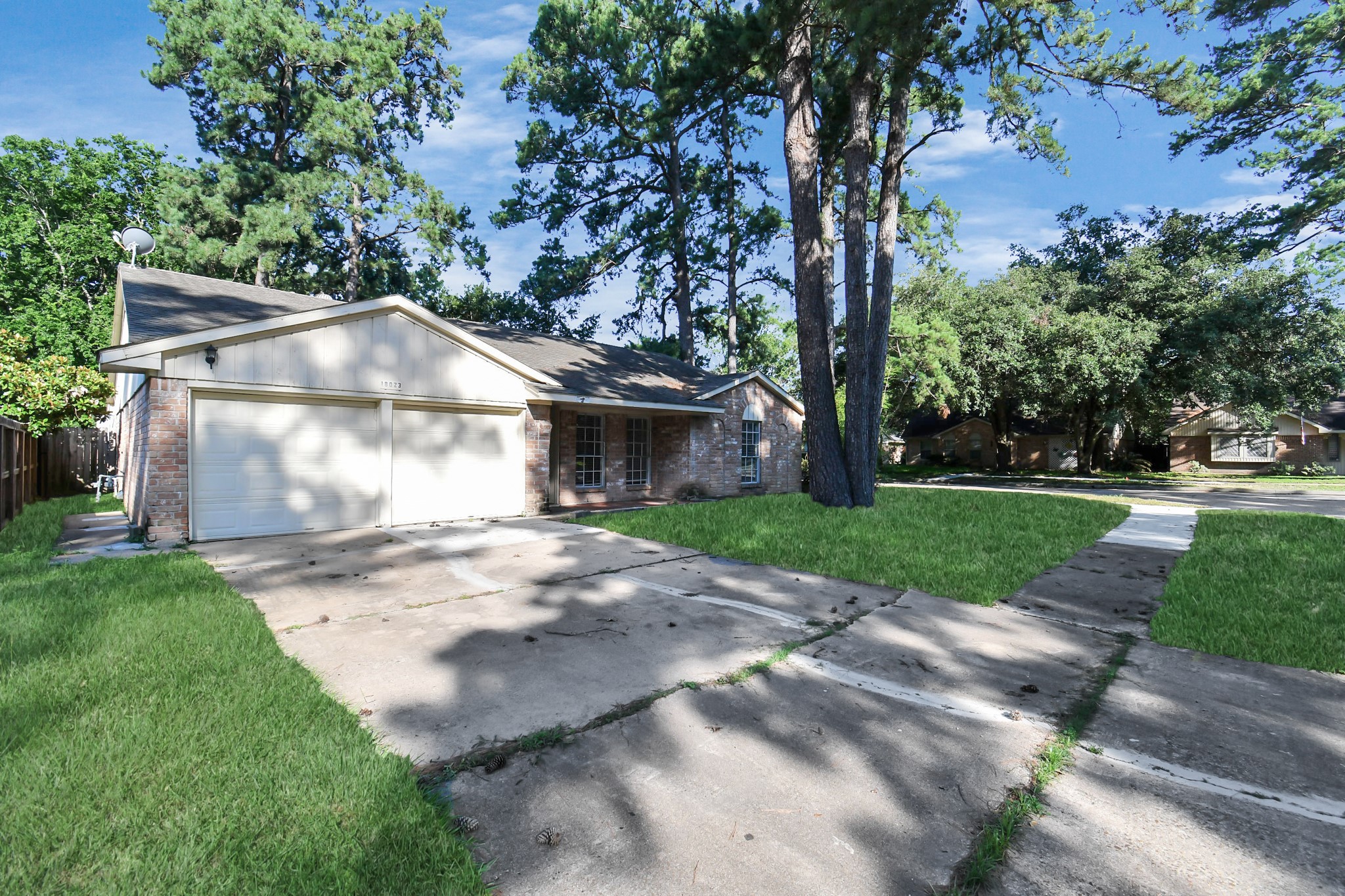 18023 Woodgum Drive Spring, TX 77388 - Photo 4 of 38 a view of a yard in front of a house with large tree