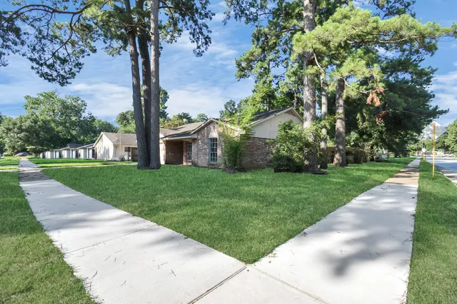 a view of a house with a tree in a park