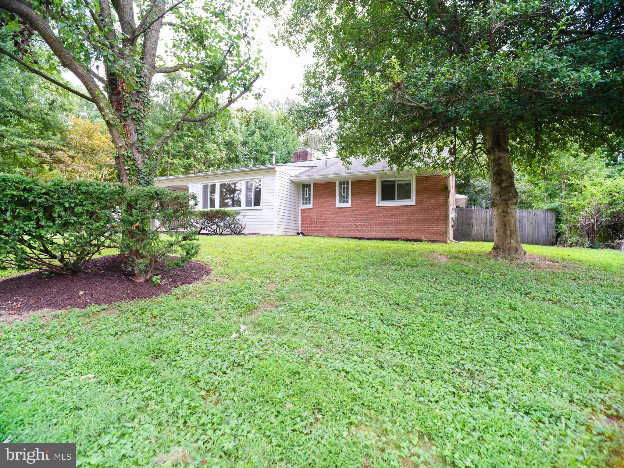 7319 Monticello Boulevard Springfield, VA 22150 - Photo 11 of 27 a front view of a house with a garden and yard