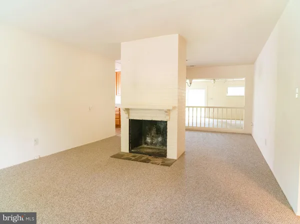 a view of an empty room with a ceiling fan