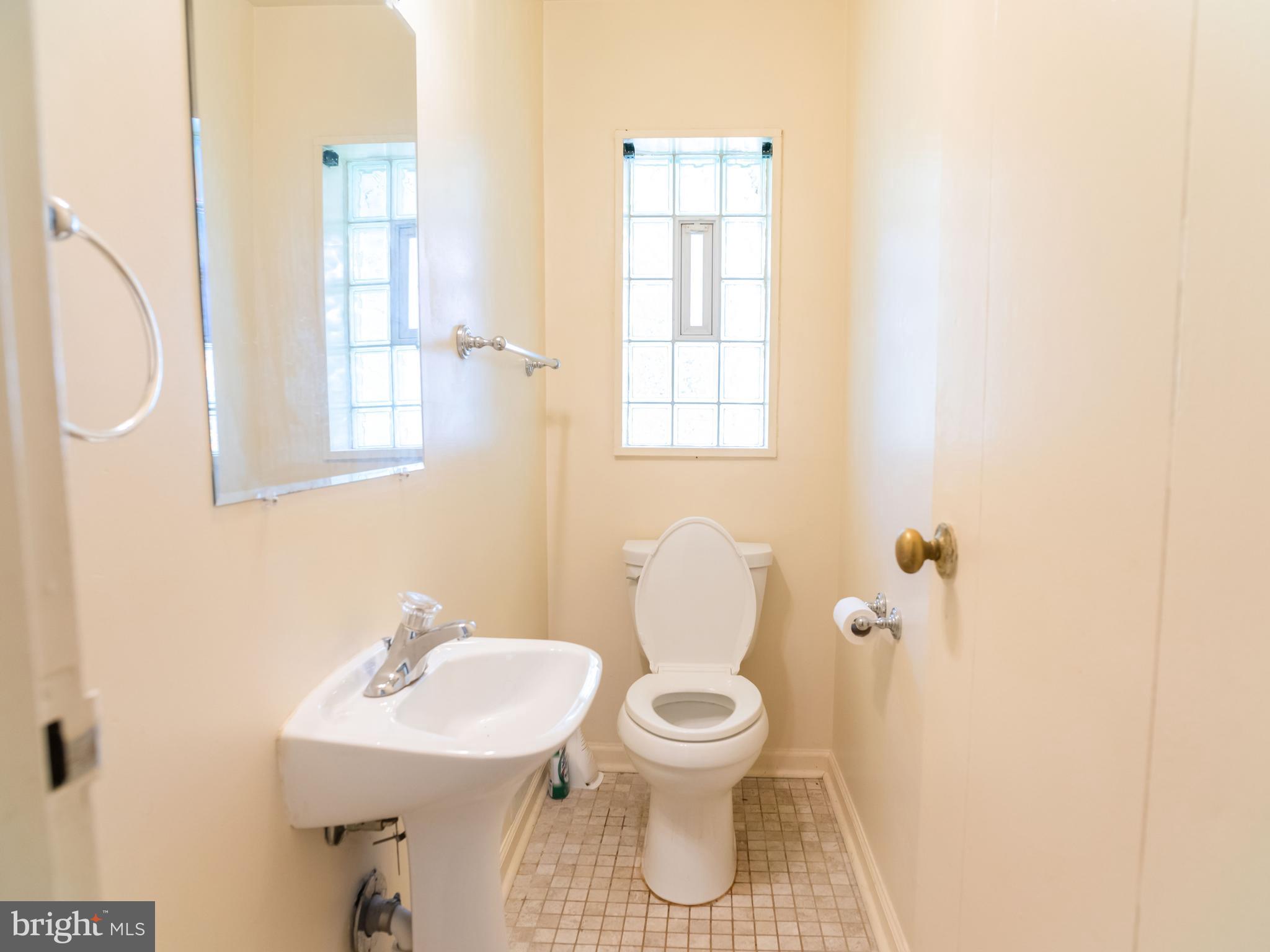 7319 Monticello Boulevard Springfield, VA 22150 - Photo 23 of 27 a bathroom with a sink toilet and a mirror