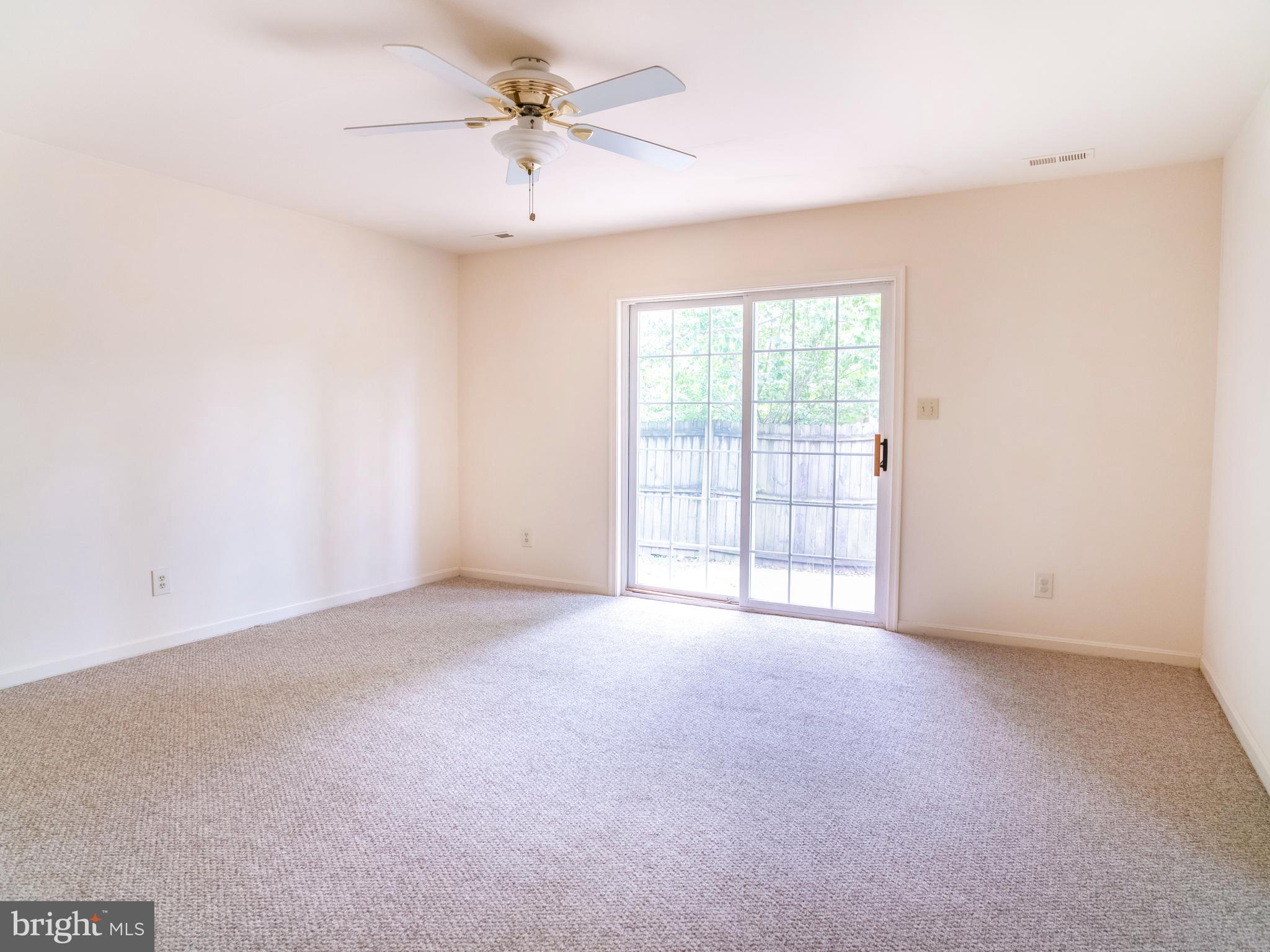 7319 Monticello Boulevard Springfield, VA 22150 - Photo 3 of 27 an empty room with chandelier fan and windows