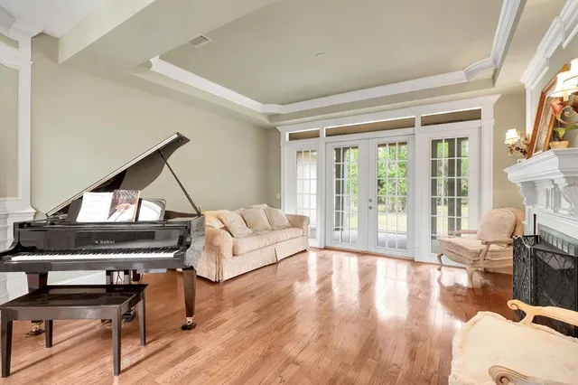 a view of a dining room with furniture large windows and wooden floor