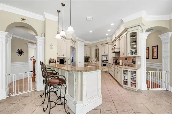 a living room with furniture a clock and a chandelier