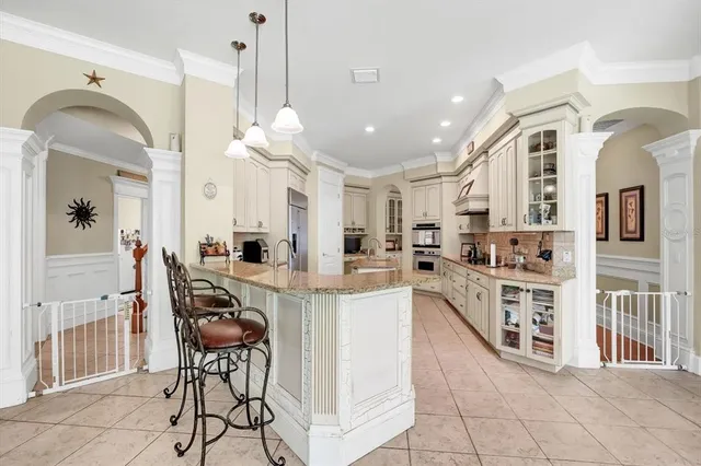 a living room with furniture a clock and a chandelier