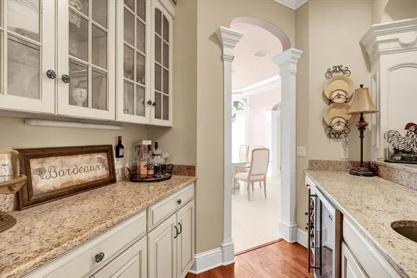 a spacious bedroom with a bed a chandelier and a large window with the outer view