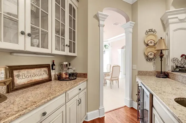 a spacious bedroom with a bed a chandelier and a large window with the outer view