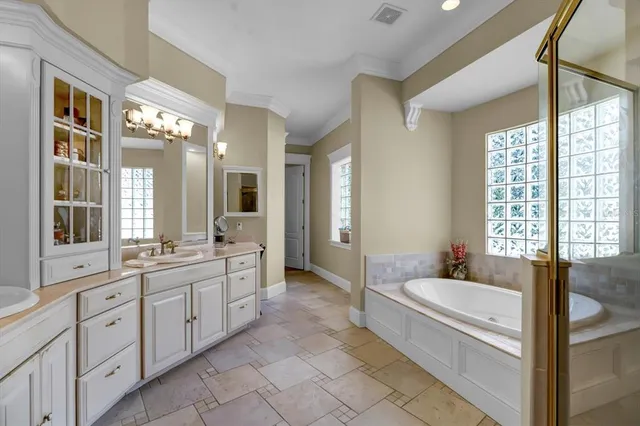 a bedroom with a bed and large windows