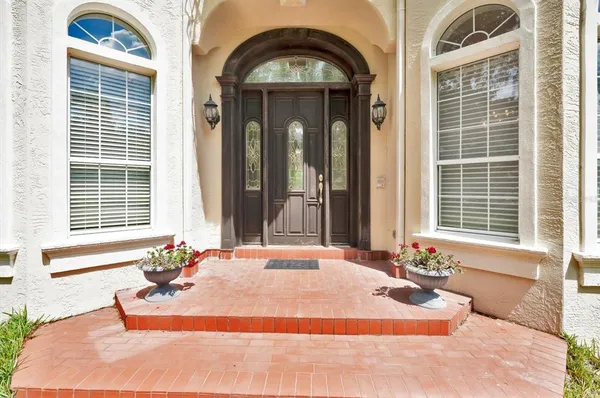 a view of a dining room with furniture and chandelier