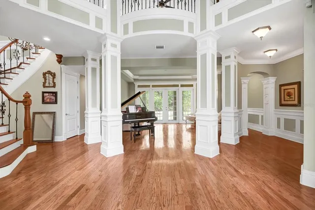 a kitchen with stainless steel appliances kitchen island granite countertop a stove a sink dishwasher a dining table and chairs with white cabinets