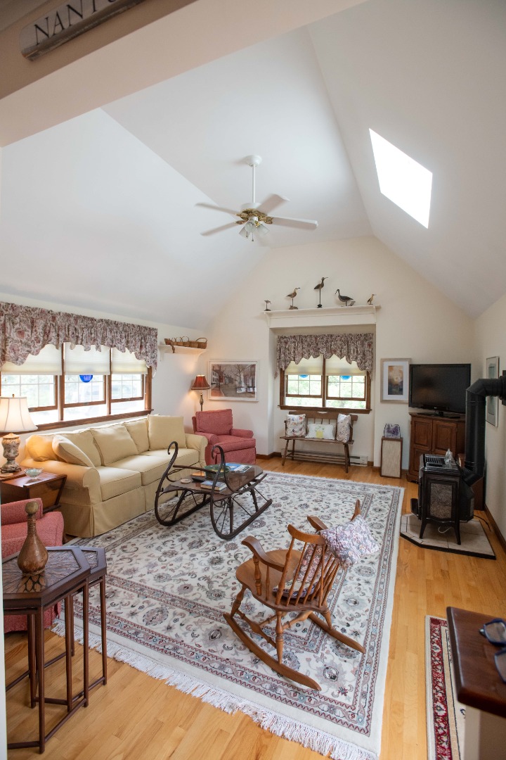 134 Surfside Road Nantucket, MA 02554 - Photo 12 of 24 a living room with furniture flat screen tv and windows