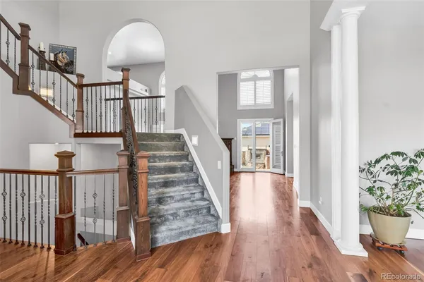 a view of staircase with wooden floor and a chandelier