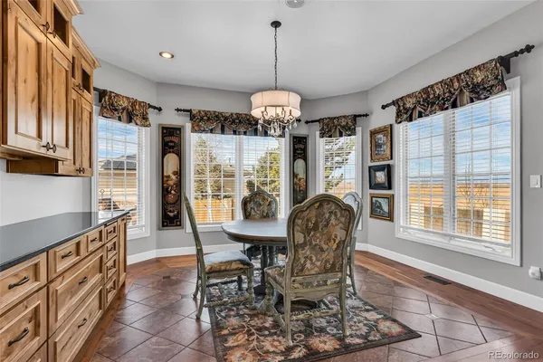 a dining room with furniture a chandelier and window