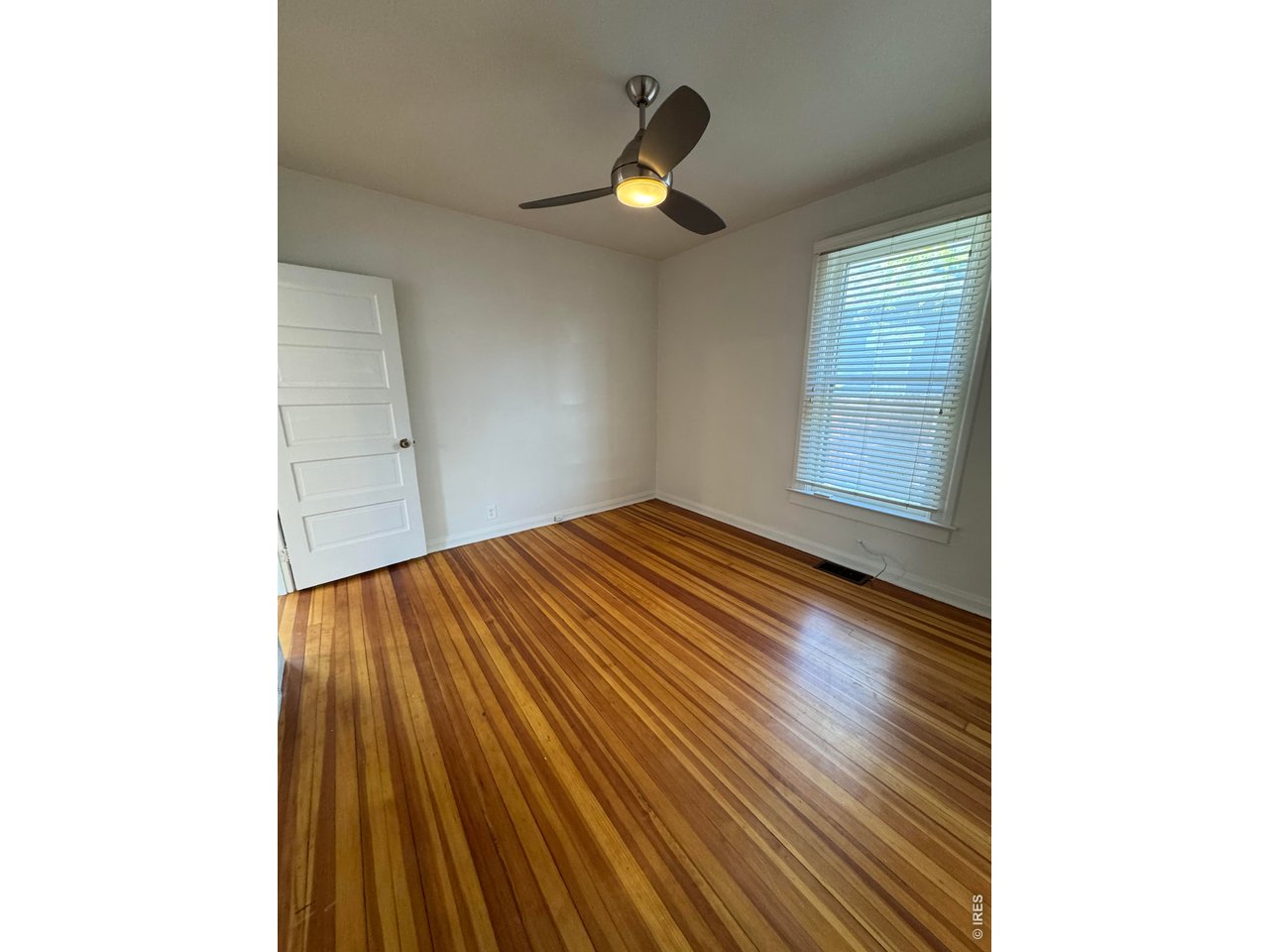 612 South Howes Street Fort Collins, CO 80521 - Photo 13 of 18 a view of empty room with wooden floor
