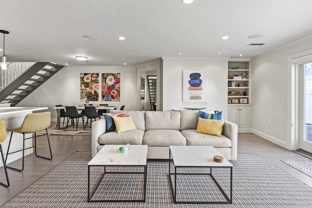 64 Cliffside Drive, Unit 64 Plymouth, MA 02360 - Photo 12 of 42 a living room with furniture a rug and a wall painting