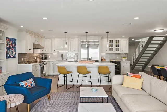 a living room with furniture and kitchen view