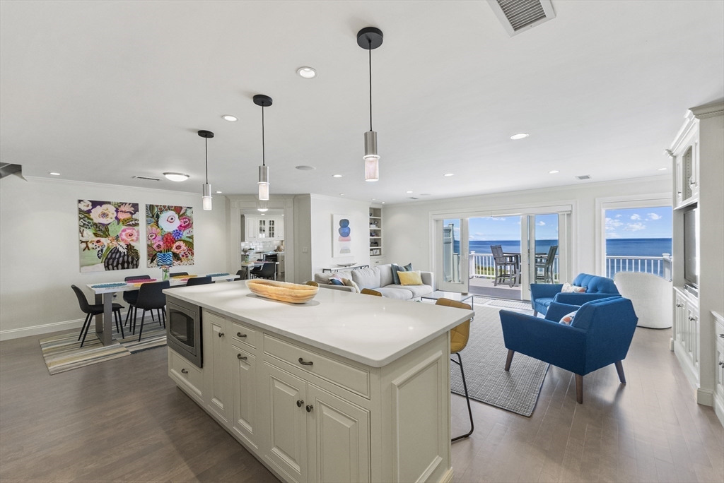 64 Cliffside Drive, Unit 64 Plymouth, MA 02360 - Photo 15 of 42 a living room with stainless steel appliances kitchen island a table chairs and a kitchen view