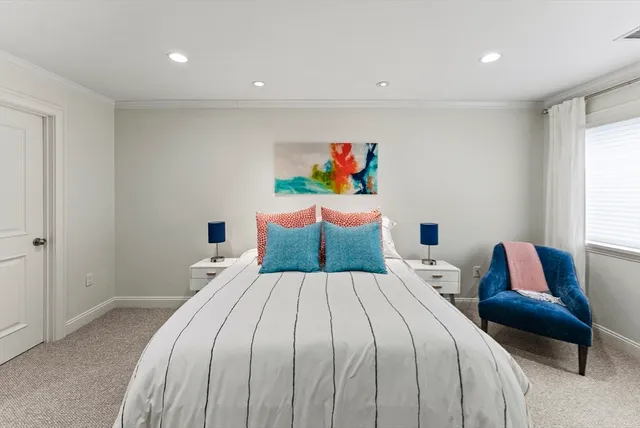 a bedroom with a bed and a couch