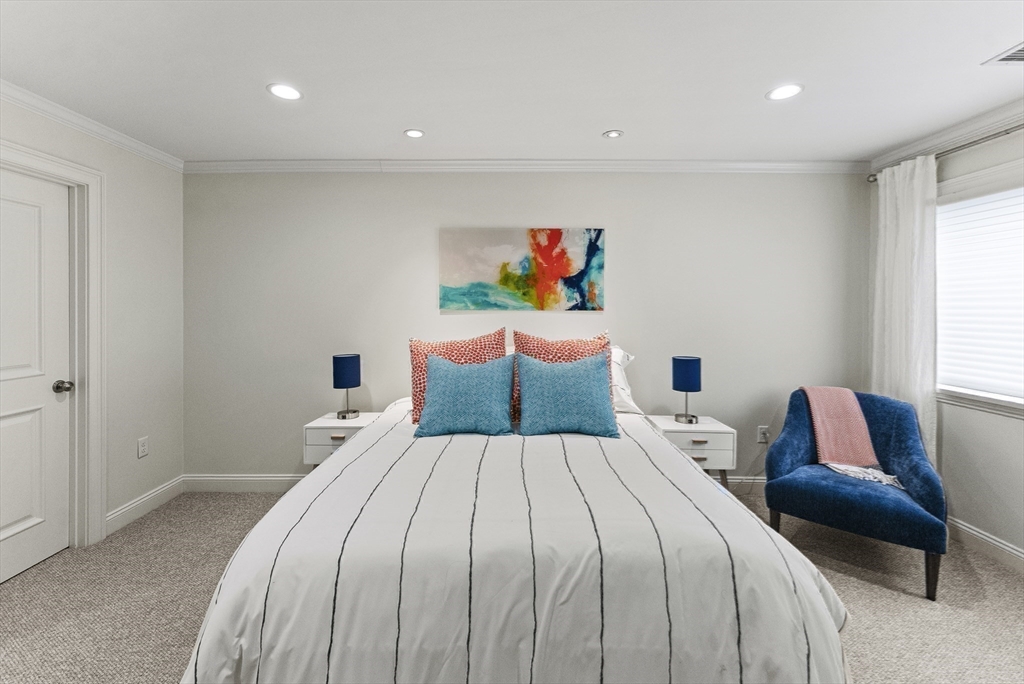 64 Cliffside Drive, Unit 64 Plymouth, MA 02360 - Photo 20 of 42 a bedroom with a bed and a couch