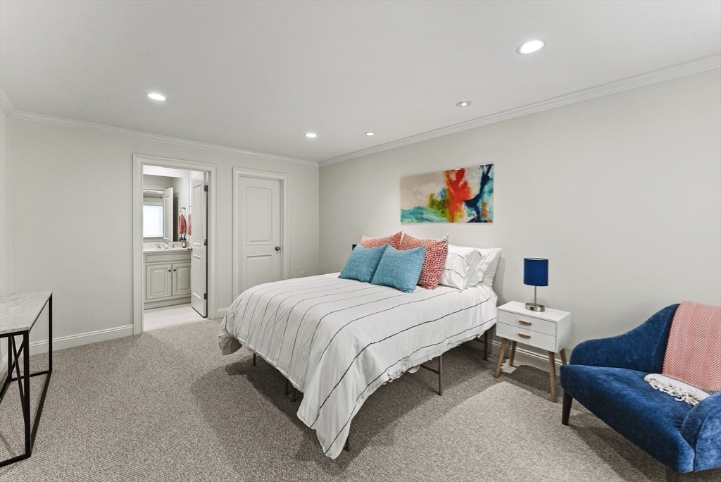 64 Cliffside Drive, Unit 64 Plymouth, MA 02360 - Photo 22 of 42 a bedroom with a bed and a couch