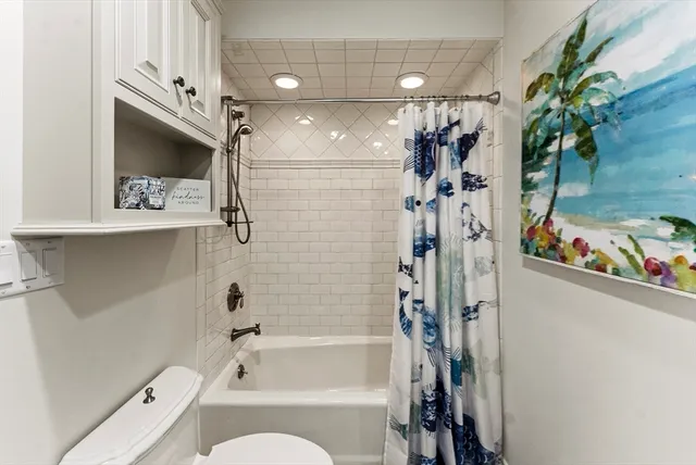 a bathroom with a tub a sink and a shower