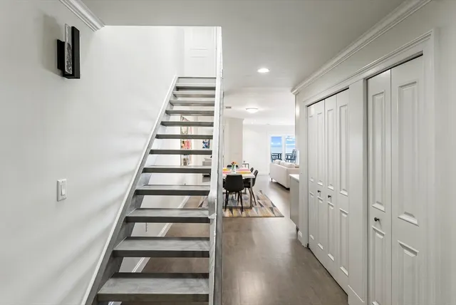 a view of entryway and hall with wooden floor