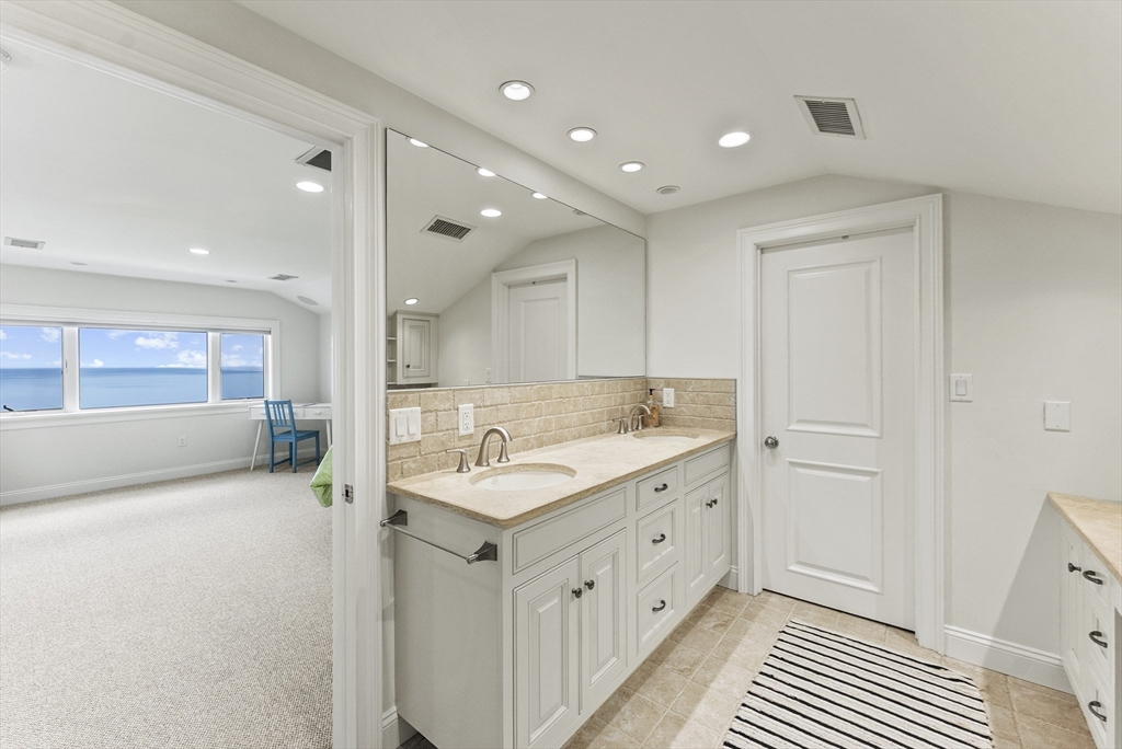 64 Cliffside Drive, Unit 64 Plymouth, MA 02360 - Photo 29 of 42 a bathroom with a double vanity sink and mirror