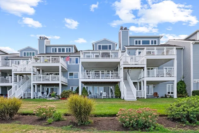 a view of a big building with a big yard and large trees