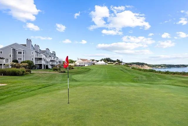 a view of a balcony with wooden floor and fence