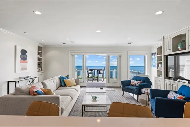 a living room with furniture and large windows